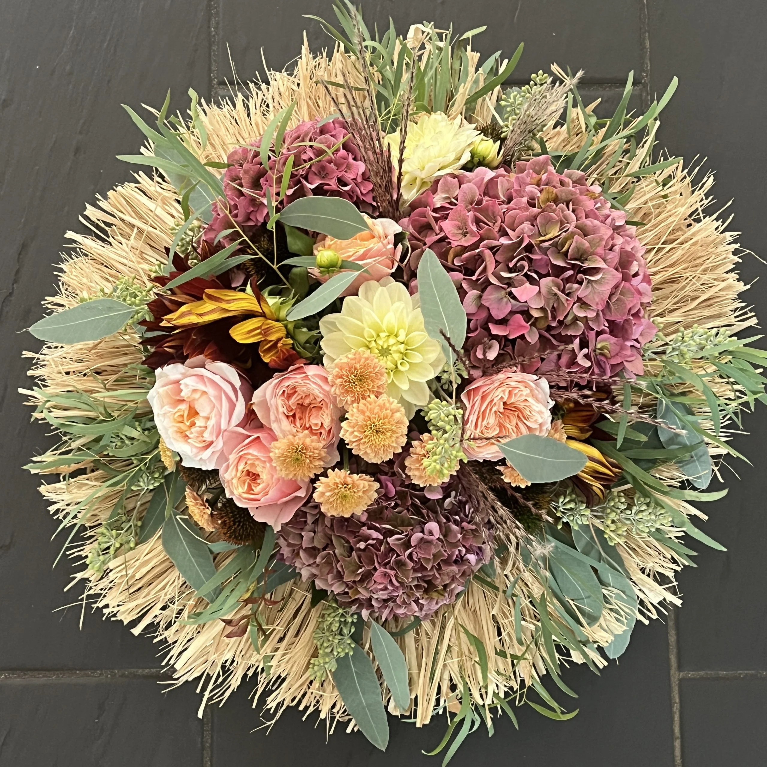 Coupe fantaisie avec couronne de raphia sur commande, par Hanakawa, fleuriste à Meudon